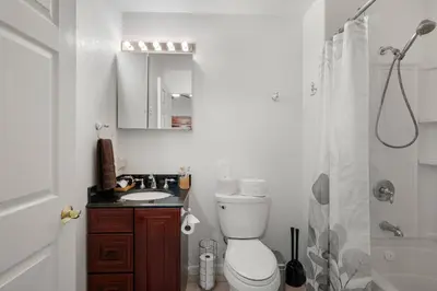 a bathroom with a toilet and a sink and a shower at Stylish 6 Bdr home, GameRoom, near Lake | Yosemite in Groveland