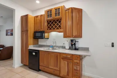 a kitchen with wooden cabinets and a sink at Yosemite-bound, Fun at the lake, Spacious & stylish 6 Bdr home with game room in Groveland