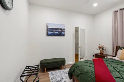 a bedroom with a bed and a chair at Yosemite-bound, Fun at the lake, Spacious & stylish 6 Bdr home with game room in Groveland