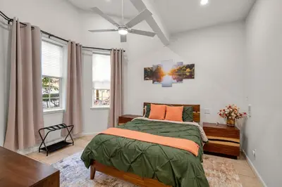 a bedroom with a bed and a ceiling fan at Yosemite-bound, Fun at the lake, Spacious & stylish 6 Bdr home with game room in Groveland