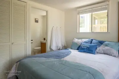 a bedroom with a bed with blue pillows on it at Lakeview Haven - Boat Slip - Dog Friendly - Sleeps 16