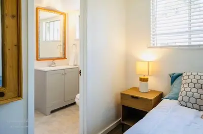a bedroom with a bed and a sink and a mirror at Lakeview Haven - Boat Slip - Dog Friendly - Sleeps 16