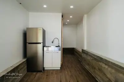 a kitchen with a refrigerator and a sink in a room at Lakeview Haven - Boat Slip - Dog Friendly - Sleeps 16
