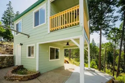 a green house with a balcony on top of it at Lakeview Haven - Boat Slip - Dog Friendly - Sleeps 16