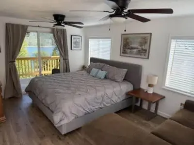 a bedroom with a bed and a ceiling fan at Lakeview Haven - Boat Slip - Dog Friendly - Sleeps 16