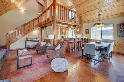 a living room with a dining room and a kitchen at 1 Mi to Tahoe Donner Skiing Luxe Truckee Cabin! in Truckee