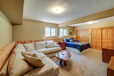 a living room with a couch and a bed at 1 Mi to Tahoe Donner Skiing Luxe Truckee Cabin! in Truckee