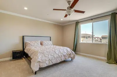a bedroom with a bed and a ceiling fan at Patio and Outdoor Kitchen Manteca Family Home in Manteca