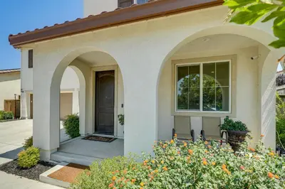 a house with arches and flowers in front of it at Patio and Outdoor Kitchen Manteca Family Home in Manteca