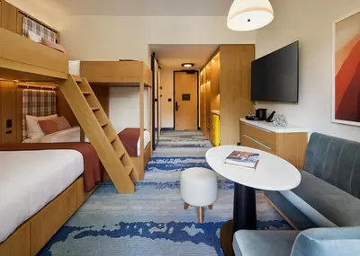 a hotel room with a bunk bed and a couch at Limelight Mammoth in Mammoth Lakes