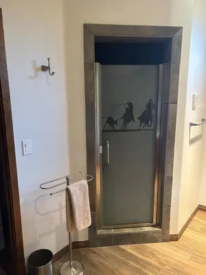 a bathroom with a shower with a glass door at Ranch Resort Suite Near Sequoias in Woodlake