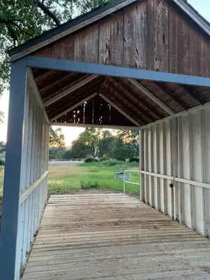 a wooden covered bridge with a wooden walkway at Ranch Resort Suite Near Sequoias in Woodlake