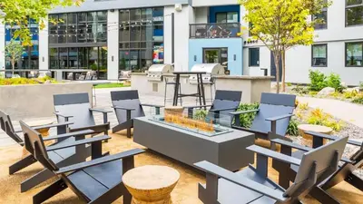 a patio with chairs and tables in front of a building at Landing at RED in Reno