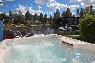 a large hot tub in a yard with a river at 2078 Traverse Court home in South Lake Tahoe