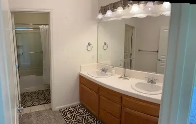 a bathroom with two sinks and a large mirror at Cozy room at la paz in Fresno
