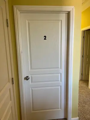 a white door with the number on it at Cozy room at la paz in Fresno