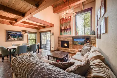 a living room with a couch and a fireplace at Northshore Lakeside Condo 15 by Tahoe Getaways - Walk to Beach with HOA in Tahoe City