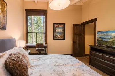 a bedroom with a bed and a flat screen tv at Northshore Lakeside Condo 15 by Tahoe Getaways - Walk to Beach with HOA in Tahoe City