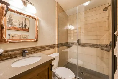 a bathroom with a toilet and a sink and a shower at Northshore Lakeside Condo 15 by Tahoe Getaways - Walk to Beach with HOA in Tahoe City
