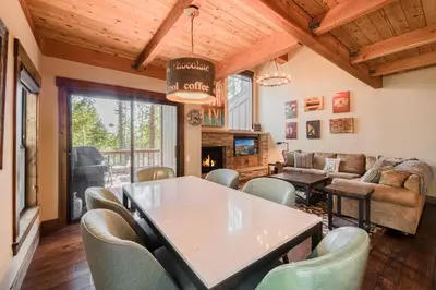 a living room with a table and chairs at Northshore Lakeside Condo 15 by Tahoe Getaways - Walk to Beach with HOA in Tahoe City