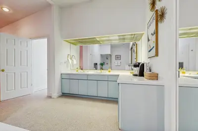 a white kitchen with a sink and a mirror at Incline Village Retreat in Incline Village