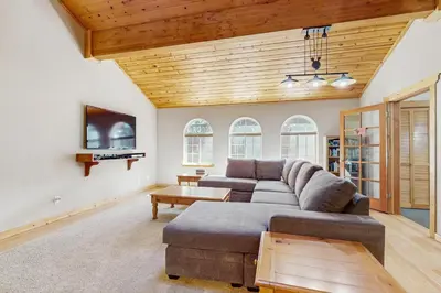 a living room with a couch and a tv at The Tahoe House in Truckee