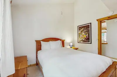 a bedroom with a white bed and a window at The Tahoe House in Truckee