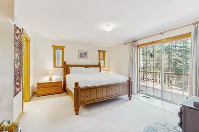 a bedroom with a bed and a large window at The Tahoe House in Truckee