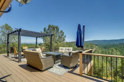 a deck with chairs and a table and an umbrella at Mtn Views and Game Room Family Retreat in Groveland in Groveland