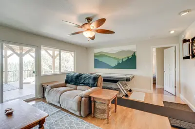 a living room with a couch and a ceiling fan at Mtn Views and Game Room Family Retreat in Groveland in Groveland