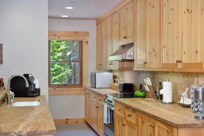 a kitchen with wooden cabinets and a counter top at Big Chief River Retreat-Located on Truckee River in Truckee