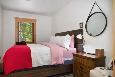 a bedroom with a bed with a mirror and a dresser at Big Chief River Retreat-Located on Truckee River in Truckee