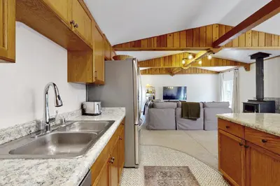 a kitchen with a sink and a refrigerator at West End Escape in Truckee