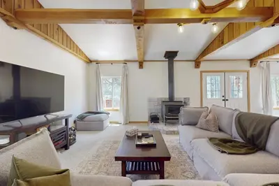 a living room with a couch and a tv at West End Escape in Truckee