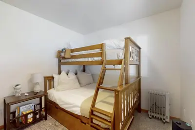 a bedroom with two bunk beds and a ladder at West End Escape in Truckee