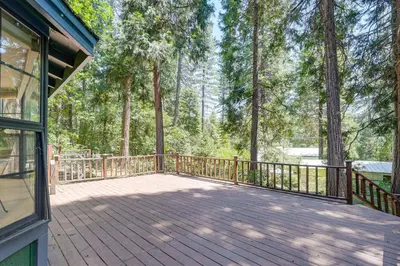 a large wooden deck with trees in the background at Private Lake Access Pet-Friendly Home in Arnold! in Arnold