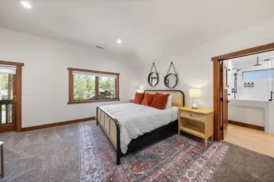a bedroom with a bed and a table and a window at Wintergreen at Tahoe Donner by Tahoe Getaways - 3BR w HOA! in Truckee