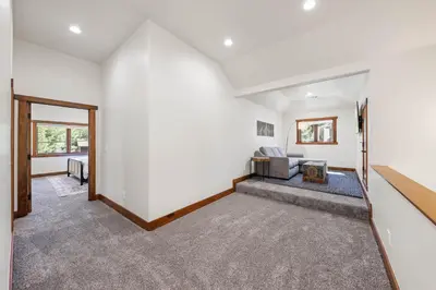 a living room with white walls and a couch at Wintergreen at Tahoe Donner by Tahoe Getaways - 3BR w HOA! in Truckee