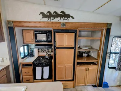 an rv kitchen with a stove and a microwave at Sierra Escape RV in Squaw Valley