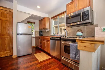 a kitchen with stainless steel appliances and wooden cabinets at Dollar Hill II # 61 By Hauserman Rentals in Tahoe City