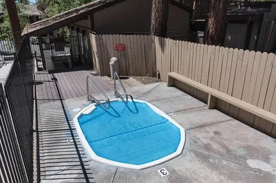 a swimming pool sitting on the ground next to a fence at Dollar Hill II # 61 By Hauserman Rentals in Tahoe City