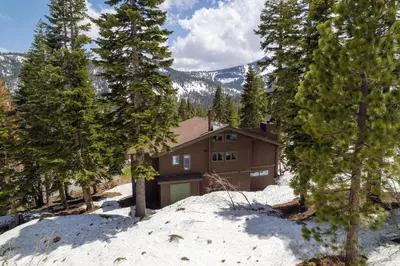 a house in the snow with trees at Alpine Retreat By Hauserman Rentals in Tahoe City