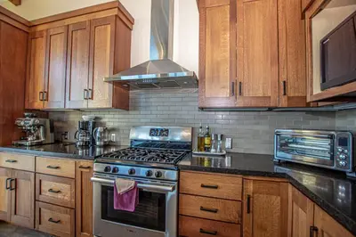 a kitchen with wooden cabinets and a stove top oven at Beautiful View By Hauserman Rentals in Tahoe City