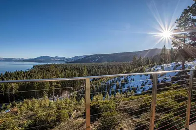a view from the balcony of a house with the sun in the sky at Beautiful View By Hauserman Rentals in Tahoe City