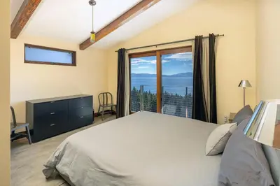 a bedroom with a bed and a large window at Beautiful View By Hauserman Rentals in Tahoe City