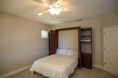 a bedroom with a bed and a ceiling fan at Hemlock Hacienda in Groveland