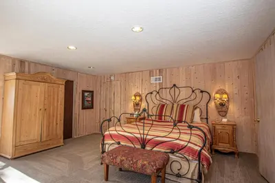 a bedroom with a bed and a wooden wall at Goetzl By Hauserman Rentals in Tahoma