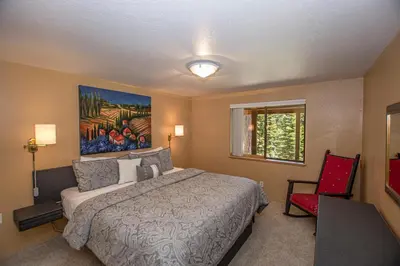 a bedroom with a bed and a painting on the wall at Big Pine By Hauserman Rentals in Tahoe City