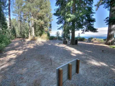 a fence in the middle of a field with trees at Big Pine By Hauserman Rentals in Tahoe City
