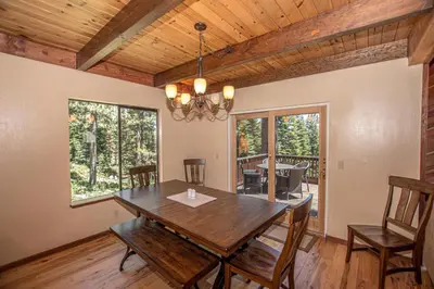 a dining room with a wooden table and chairs at Big Pine By Hauserman Rentals in Tahoe City